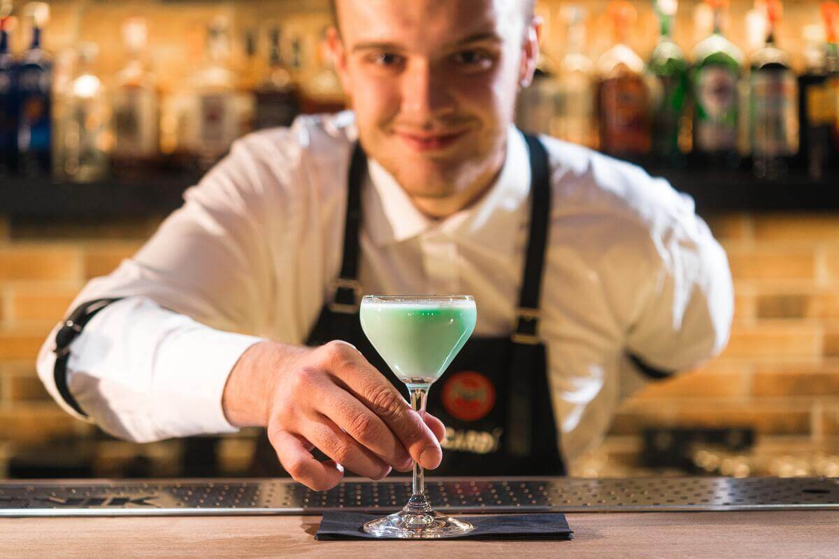 delivering drink Why Hiring a Professional Bartender for Your Wedding is Worth the Cost