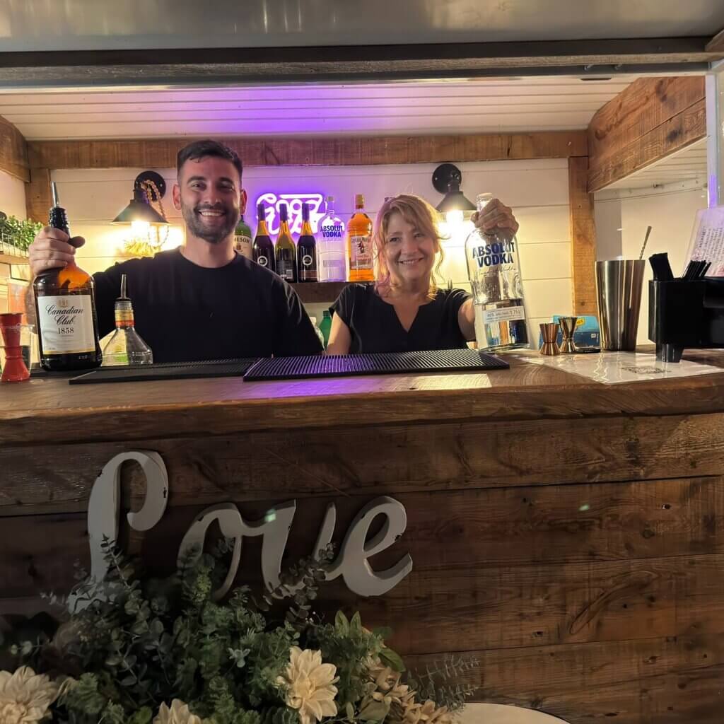 Professional wedding bartenders working behind a reception bar