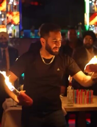Flair bartender performing a bottle flair routine at a Toronto event